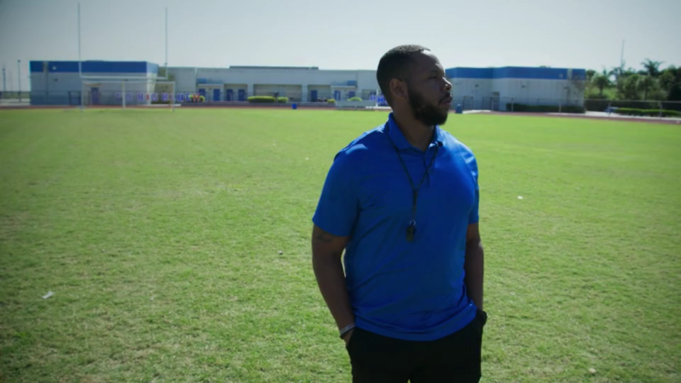 Pahokee football coach DJ Boldin standing in the stadium named for his brother, Anquan.