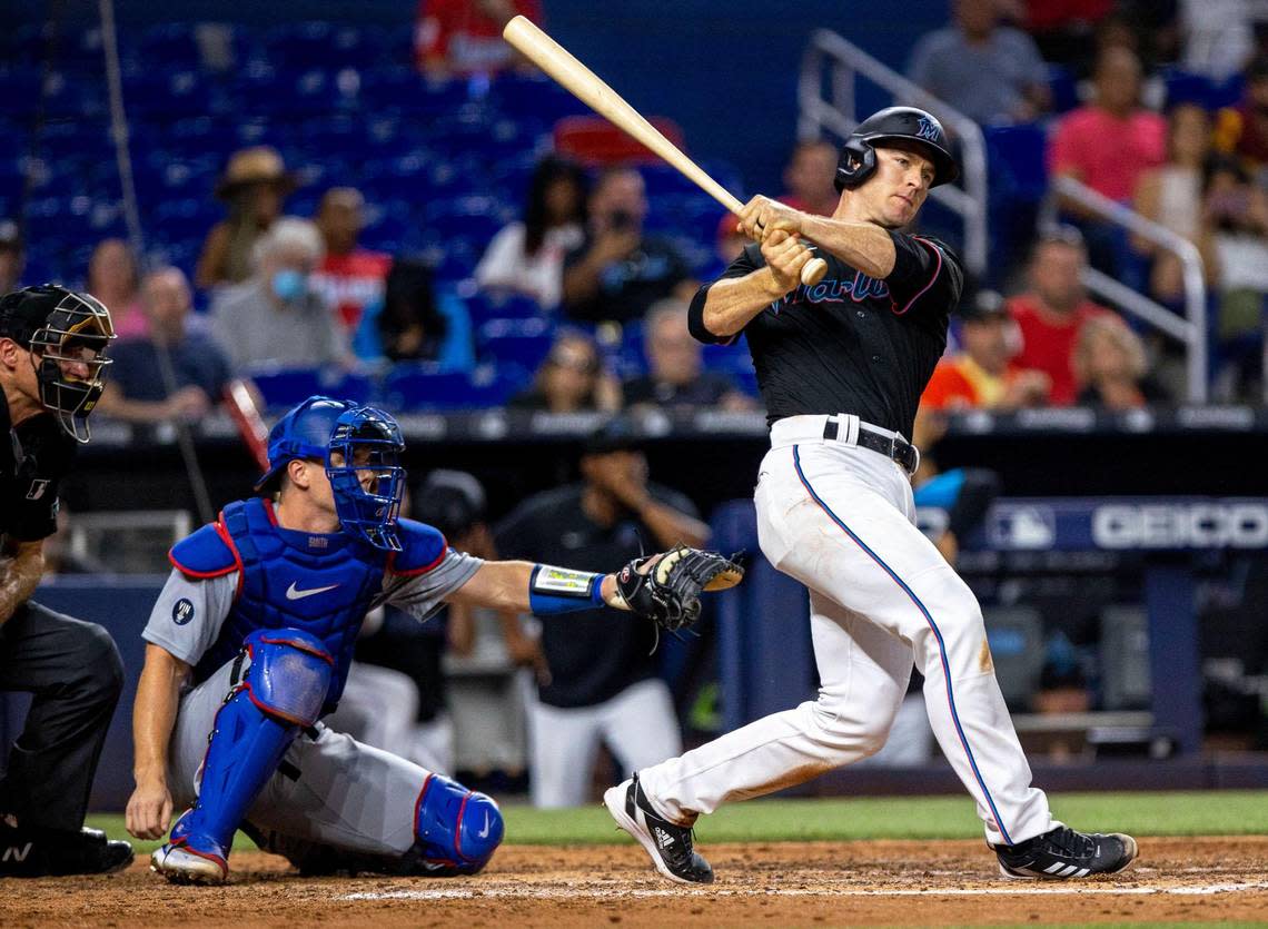 Miami Marlins batter Joey Wendle (18) doubles on a ground ball to right field allowing teammates Peyton Burdick (86) and Miguel Rojas (11) to score runs during the sixth inning of an MLB game against the Los Angeles Dodgers at loanDepot park in the Little Havana neighborhood of Miami, Florida, on Friday, August 26, 2022.