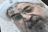 <p>Pictures of Ruhollah Khomeini and Hassan Rohani are stomped on by protesters in front of the Embassy of Iran on Jan. 4, 2018 in Paris, France. (Photo: Julien Mattia/NurPhoto via ZUMA Press) </p>