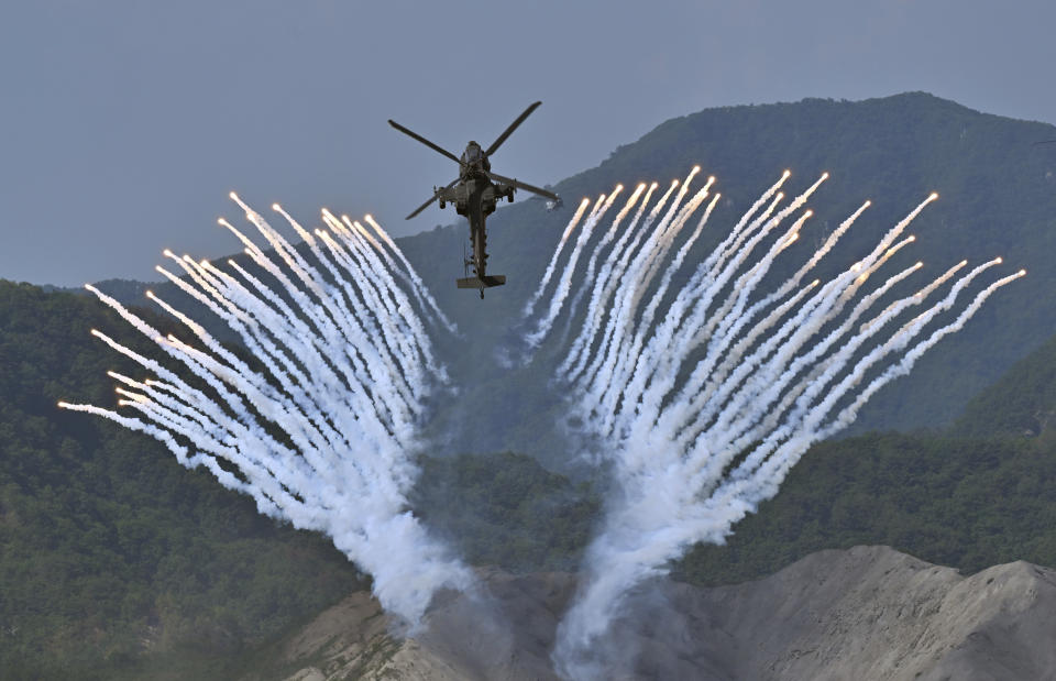 South Korea's Apache AH-64 helicopter fires flares during a South Korea-U.S. joint military drill at Seungjin Fire Training Field in Pocheon, South Korea Thursday, June 15, 2023. (Jung Yeon-je/Pool Photo via AP)