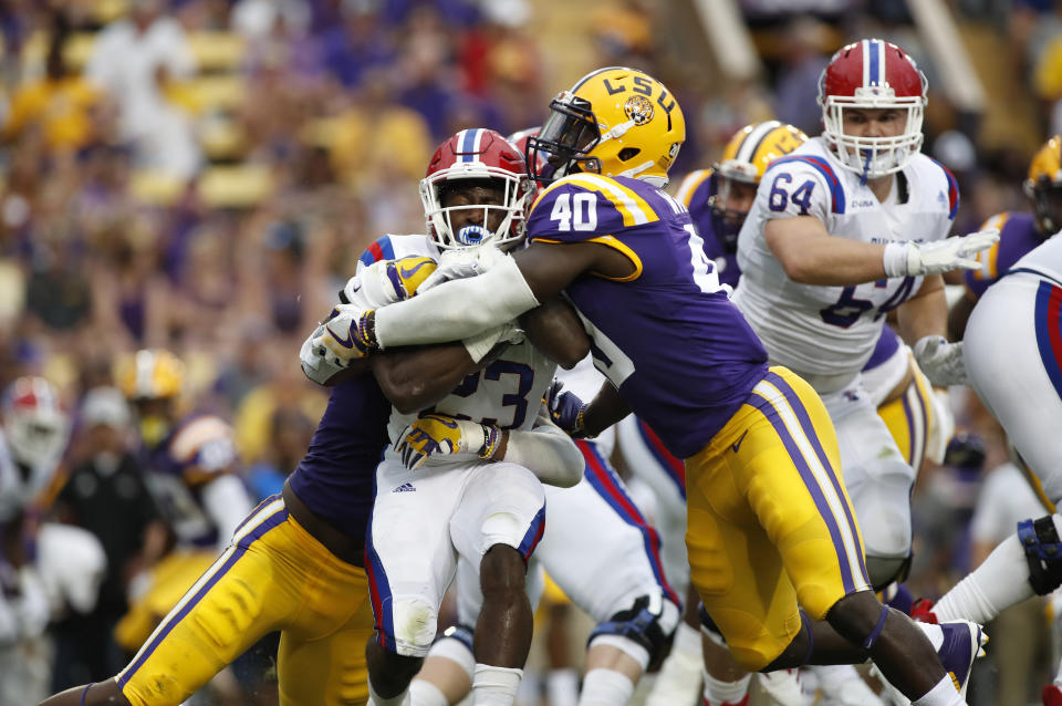 FILE - In this Sept. 22, 2016, file photo, LSU linebacker Devin White (40) stops Louisiana Tech running back Jaqwis Dancy (23) in the first half of a game in Baton Rouge, La. White was named to the 2018 AP All-America NCAA college football team, Monday, Dec. 10, 2018. (AP Photo/Tyler Kaufman, File)