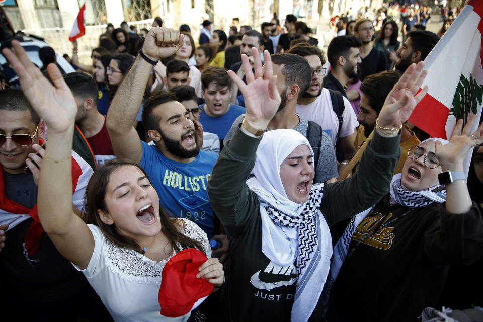 University students chant slogans against the Lebanese government, in Beirut, Tuesday, Nov. 12, 2019. Protesters in Lebanon resumed demonstrations on Tuesday blocking some roads and governmental institutions. (AP Photo/Bilal Hussein)