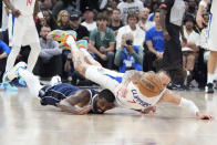 Los Angeles Clippers guard Amir Coffey, right, and Dallas Mavericks guard Kyrie Irving dive for a loose ball during the second half in Game 5 of an NBA basketball first-round playoff series Wednesday, May 1, 2024, in Los Angeles. (AP Photo/Mark J. Terrill)