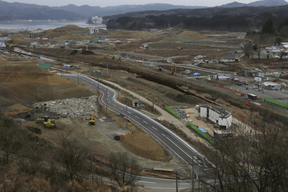 In this March 7, 2016, file photo, construction works go on in the leveled city of Minamisanriku, Miyagi Prefecture, northeastern Japan, almost five years after the March 11, 2011 tsunami. (AP Photo/Eugene Hoshiko, File)