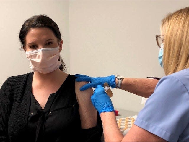 Laila Reed, quality manager nurse at Community Medical Center in Toms River, receives a booster shot of the Moderna vaccine.