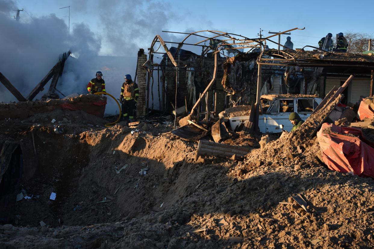 Members of the Ukrainian State Emergency Service clear the rubble at the building which was destroyed as a result of Russian strike in Zaporizhzhia district, Ukraine, Friday, March 31, 2023 (AP)