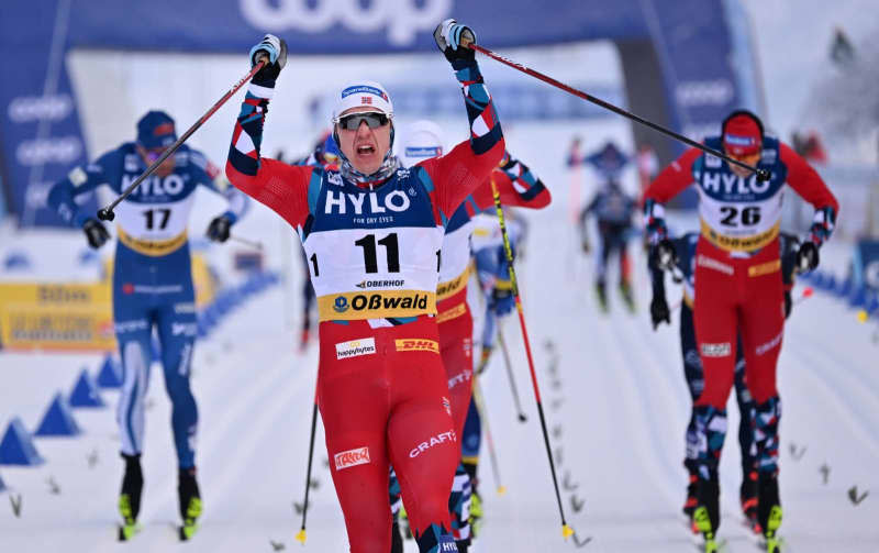 Norway's Erik Valnes celebrates at the finish line of the mass start classic over 20 kilometers during the cross-country skiing World Cup in Oberhof. Martin Schutt/dpa