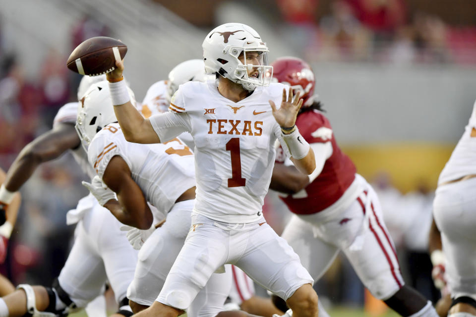 Texas quarterback Hudson Card (1) drops back to pass against Arkansas during the first half of an NCAA college football game Saturday, Sept. 11, 2021, in Fayetteville, Ark. (AP Photo/Michael Woods)