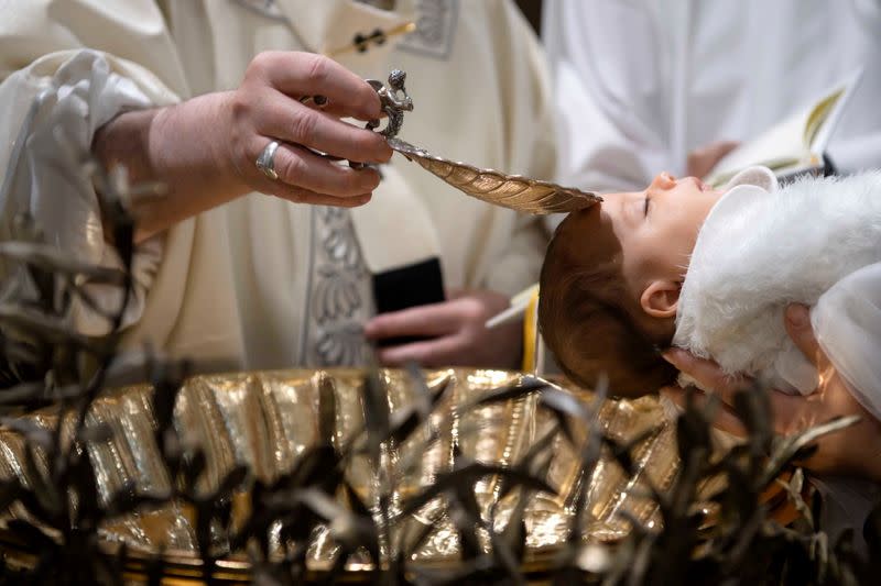 FILE PHOTO: Pope Francis baptises a baby during a Mass in the Sistine Chapel at the Vatican