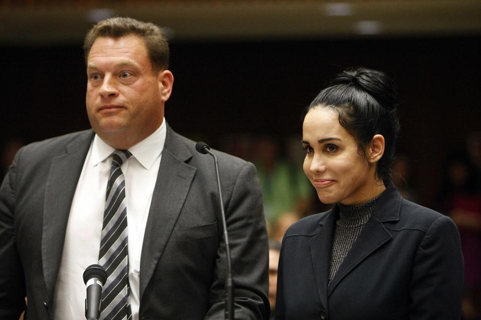 Nadya Suleman appears with her attorney Arthur J. La Cilento (L) for arraignment in Los Angeles, California January 17, 2014. Suleman, the California single mother of 14 children including octuplets who has been popularly dubbed "Octomom," has been charged with welfare fraud over accusations she lied about her income to authorities, prosecutors said on Monday. REUTERS/Al Seib/Pool (UNITED STATES - Tags: CRIME LAW PROFILE)