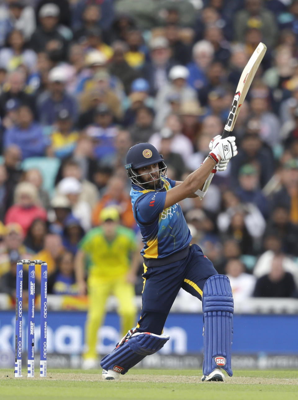 Sri Lanka's Kusal Mendis plays a shot for six off the bowling of Australia's Mitchell Starc during the World Cup cricket match between Sri Lanka and Australia at The Oval in London, Saturday, June 15, 2019. (AP Photo/Kirsty Wigglesworth)