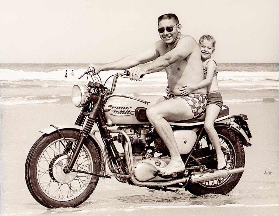 Edward "Fireball" Roberts, drives the beach in 1964 with passenger Tammy Wilson, 6, only a few months before his death.