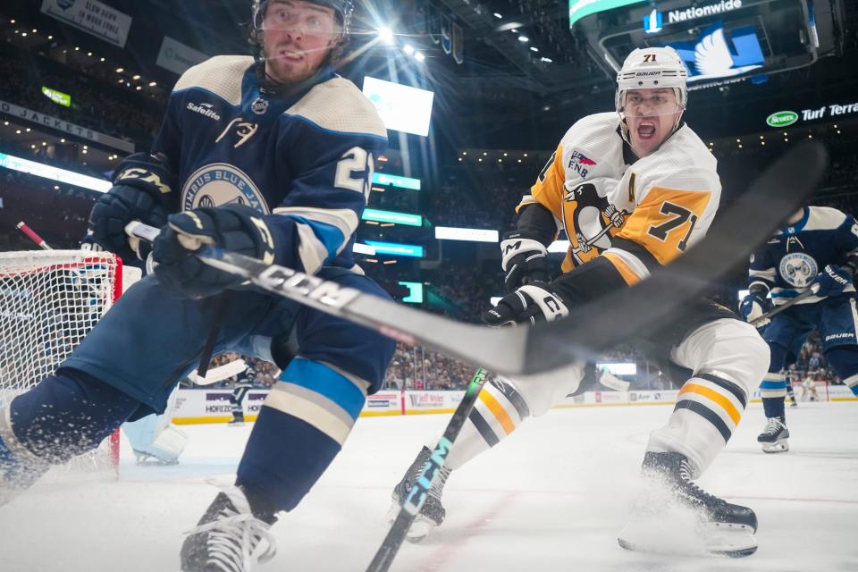 Mar 30, 2024; Columbus, Ohio, USA; Columbus Blue Jackets defenseman Jake Christiansen (23) races to a puck in front of Pittsburgh Penguins center Evgeni Malkin (71) in the second period of the NHL hockey game at Nationwide Arena.