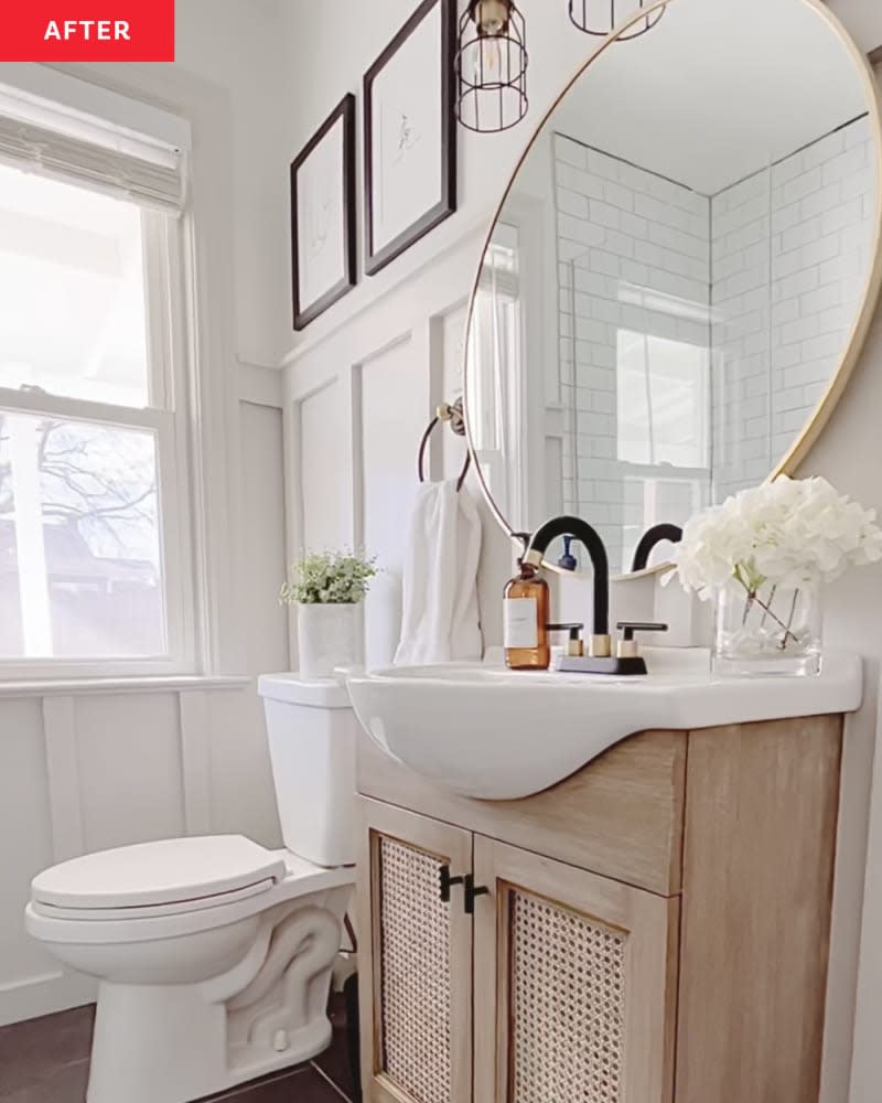 After: Bathroom with circular mirror and light wood vanity