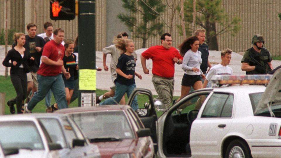 PHOTO: Columbine High School students run from the school after gunmen opened fire on students, in Littleton, Colorado, Apr. 20, 1999.  (Gary Caskey/Reuters)