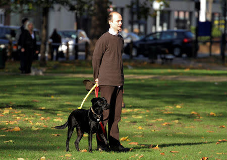 A man watches a Remembrance Sunday parade through Fulham in West London, Britain November 13, 2011. REUTERS/Kevin Coombs SEARCH "REMEMBRANCE WATCHING" FOR THIS STORY. SEARCH "WIDER IMAGE" FOR ALL STORIES.