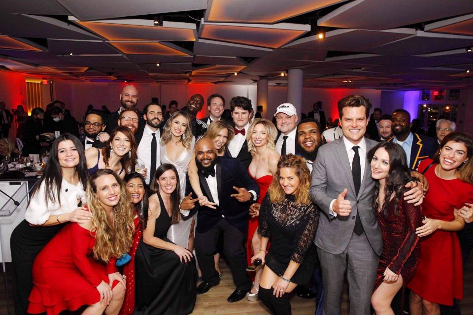 This image provided by the New York Young Republican Club, shows U.S. Rep. Matt Gaetz, R-Fla, foreground right, as he poses with attendees at the organization's 108th Annual Gala in Jersey City, N.J., on Thursday, Dec. 3, 2020. The New Jersey restaurant that hosted the political gala put on by the New York Republican Club was ordered temporarily closed Friday, Dec. 4, 2020, over potential violations of coronavirus guidelines. (Courtesy New York Republican Club via AP)