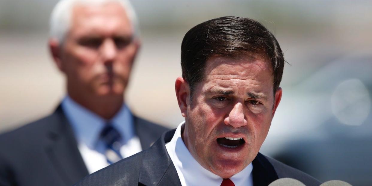 Arizona Gov. Doug Ducey, right, speaks as Vice President Mike Pence, left, watches after the two held a meeting to discuss the surge in coronavirus cases in Arizona Wednesday, July 1, 2020, in Phoenix.