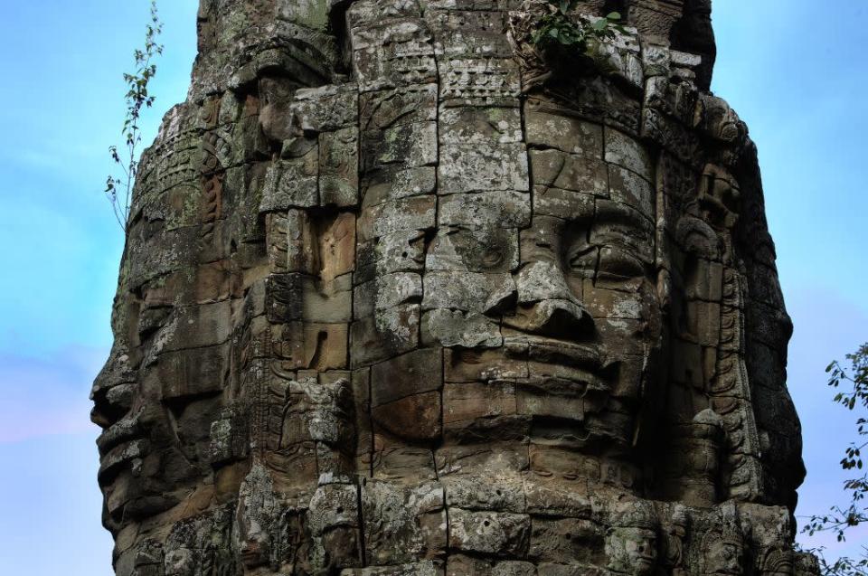 Weathered faces atop the spires of the Bayon temple in the Angkor Archeological Park.