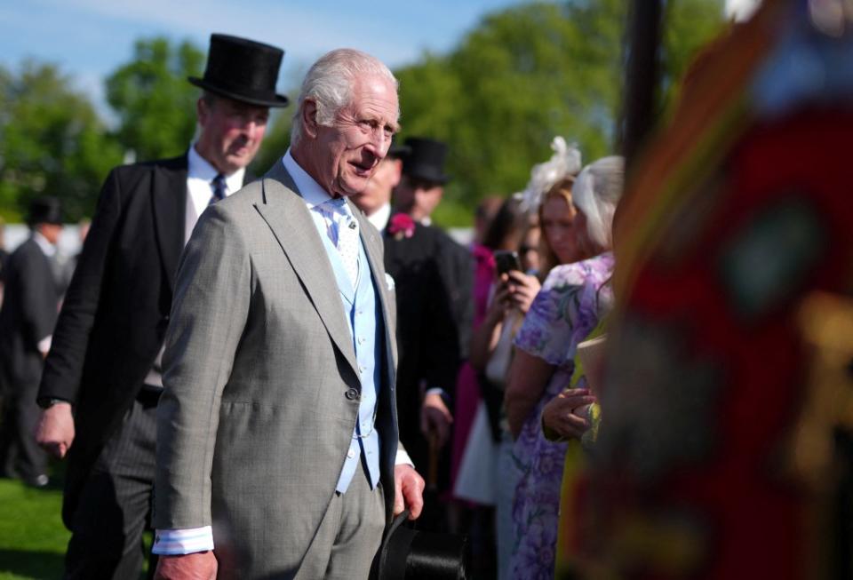 King Charles III greets guests at a royal garden party in London on May 8. via REUTERS