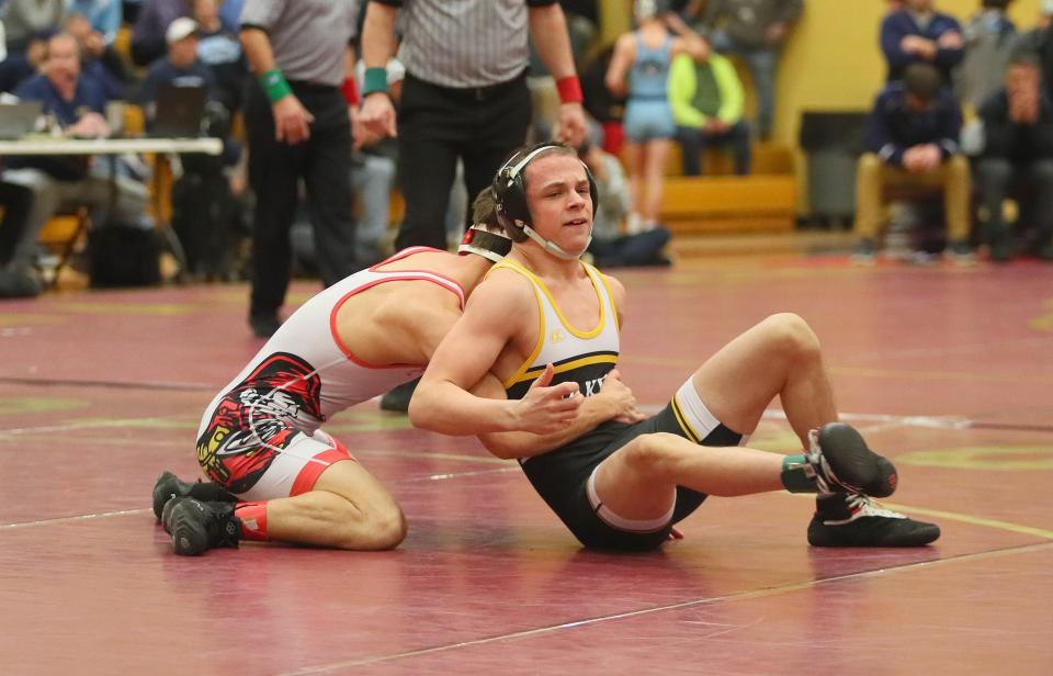 Quaker Valley's Issac Maccaglia (black) throws his body to the side to get away from Frazier's Seth Haller (red) during their 114 pound match while competing in the WPIAL 2A Wrestling Team Third Place Consolation match Saturday afternoon at Chartiers-Houston High School in Houston, PA.