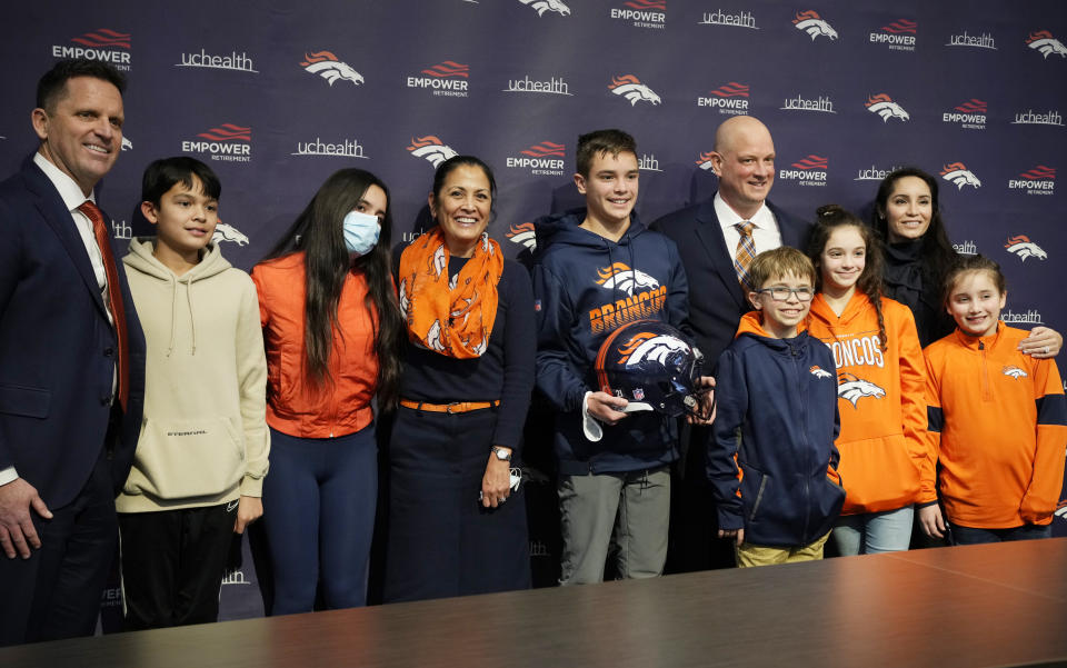From left, Denver Broncos general manager George Paton, his son Beau, 13, daughter Bella, 15, and wife Barb join the family of new Broncos head coach Nathaniel Hackett, six from left, and his children Harrison, 13, London, 11, Briar, 12, Everly, 9, and wife Megan for a photograph after a news conference Friday, Jan. 28, 2022, at the NFL football team's headquarters in Englewood, Colo. (AP Photo/David Zalubowski)