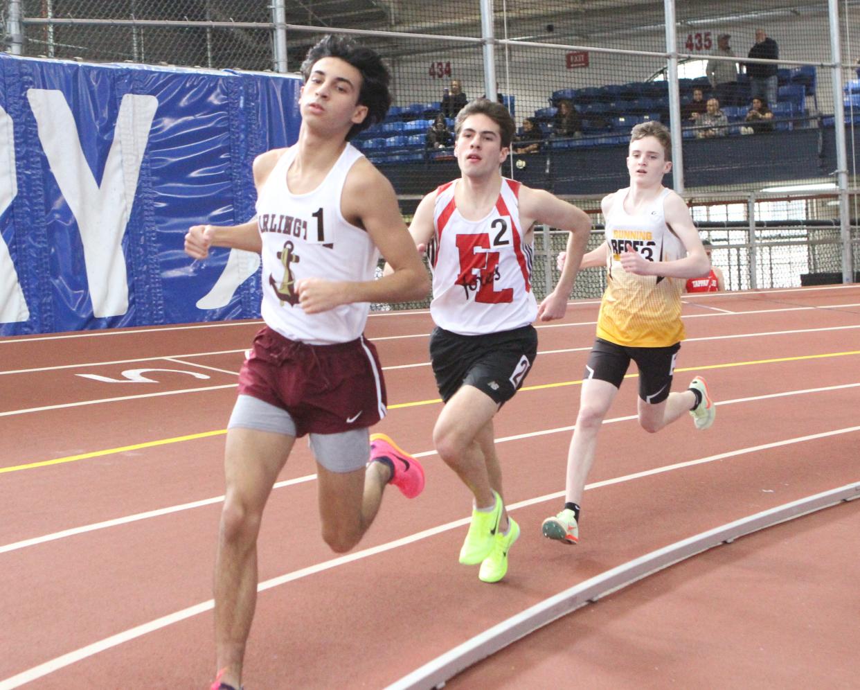 Arlington's Ethan Green (l), Fox Lane's Noah Bender (c) and Lakeland-Panas's' Bobby Mayclim (r) compete in the 3,200  at the Section 1 State Track and Field Qualifier at The Armory Feb. 19, 2023. The three qualified for the state championship.