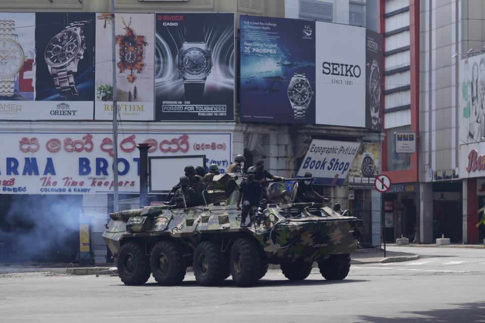 Sri Lankan army soldiers patrol during curfew in Colombo, Sri Lanka, Wednesday, May 11, 2022. Sri Lanka's defense ministry ordered security forces on Tuesday to shoot anyone causing injury to people or property to contain widespread arson and mob violence targeting government supporters. (AP Photo/Eranga Jayawardena)