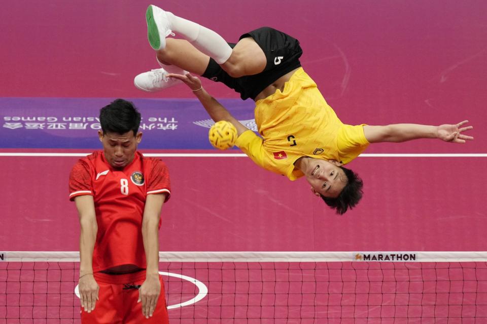 Vietnam's Nguyen Van Ly returns a rattan ball during men's sepaktakraw preliminary Group A match against Indonesia at Jinhua Sports Centre at the 19th Asian Games in Jinhua, China, Sunday, Oct. 1, 2023. (AP Photo/Eugene Hoshiko)