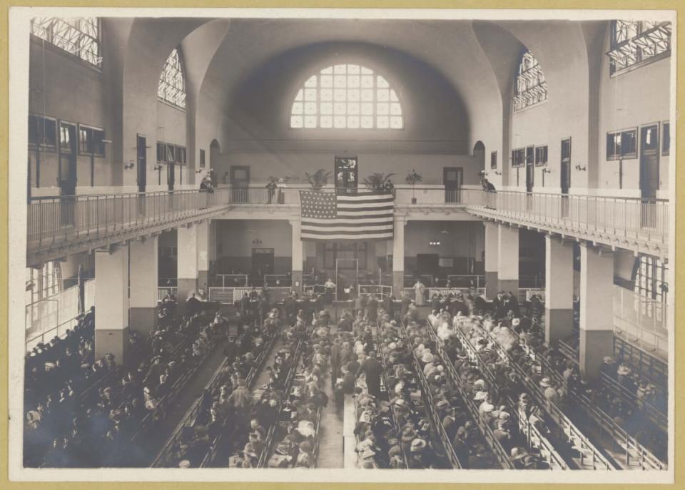 <div class="inline-image__caption"><p>Immigrants seated on long benches, Main Hall, U.S. Immigration Station at Ellis Island in 1902 or 1913.</p></div> <div class="inline-image__credit">Courtesy of The New York Public Library</div>