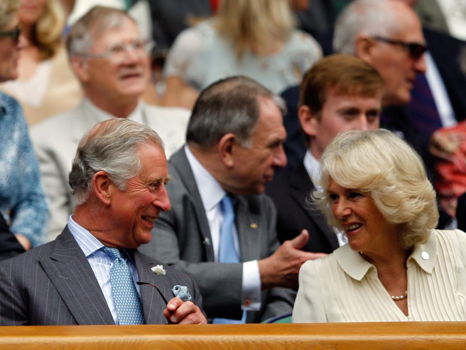 Prince Charles, Prince of Wales and Camilla, Duchess of Cornwall watch from the crowd as Roger Federer of Switzerland plays Fabio Fognini of Italy in their Gentlemen's Singles second round match on day three of the Wimbledon Lawn Tennis Championships at the All England Lawn Tennis and Croquet Club on June 27, 2012 in London, England.