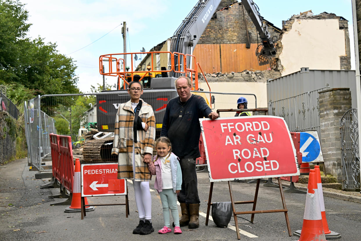 A defiant family has been left with no neighbours after refusing to move from a demolished street.

Mum-of-one Sophie Kendall, 28, grew up in the home that sits in the middle of a terraced row of houses. 

Work has begun to demolish the street after the houses were deemed at risk of a landslip in 2017.

Sophie and her family say they have had no offers from the council since their insurers have that their home is safe.

Pictured here is Sophie Kendall who lives in the house with daughter Jorgie-May, four, and stepdad Richard Morrison.

WALES NEWS SERVICE 


