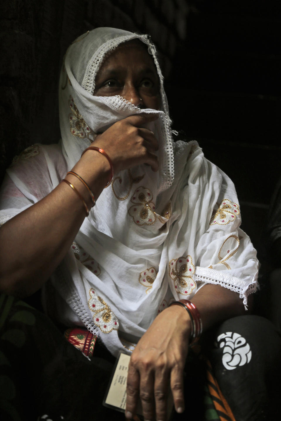 An Indian Muslim woman waits to cast her vote at a polling booth in Uluberia, India, Monday, May 6, 2019. With 900 million of India's 1.3 billion people registered to vote, the Indian national election is the world's largest democratic exercise. (AP Photo/Bikas Das)