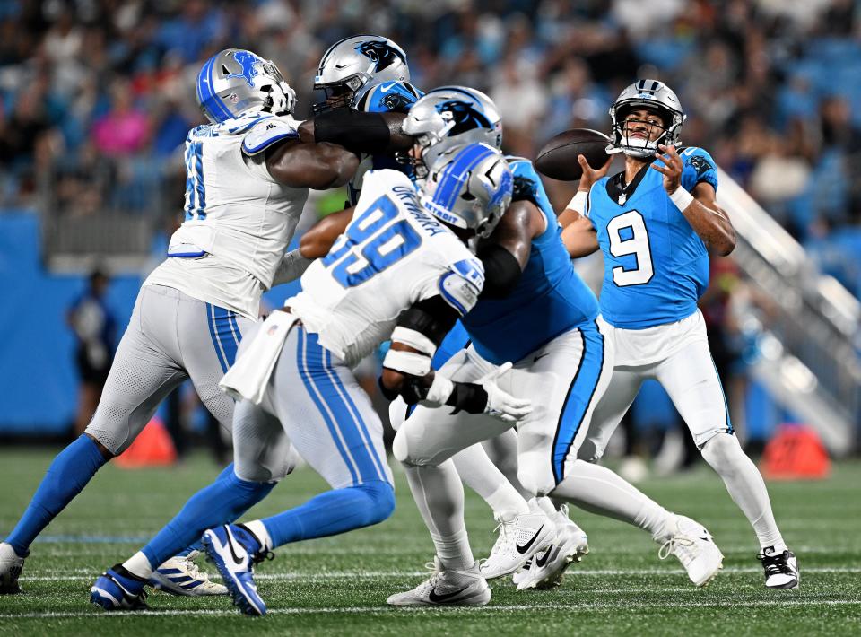Detroit Lions defensive end Julian Okwara (99) tries to pressure Carolina Panthers quarterback Bryce Young during the first half of a preseason game at Bank of America Stadium on August 25, 2023 in Charlotte, North Carolina.