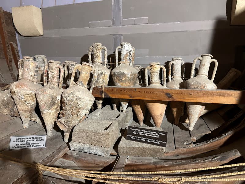 Amphoras and grain mills are seen in a museum, in Cyprus