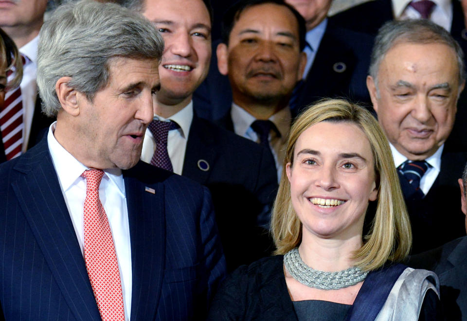 U.S. Secretary of State John Kerry (L) and Italy's Foreign Minister Federica Mogherini (R) pose for a family photo together with ambassadors and delegates at the end of the meeting on Libya at the Italian Foreign Ministry headquarters in Rome on March 6, 2014. Kerry will meet with his counterparts from Italy, France and Germany in Rome to discuss the crisis in Ukraine in a talks were being held on the sidelines of an international meeting on Libya. (Photo credit should read ALBERTO PIZZOLI/AFP/Getty Images)