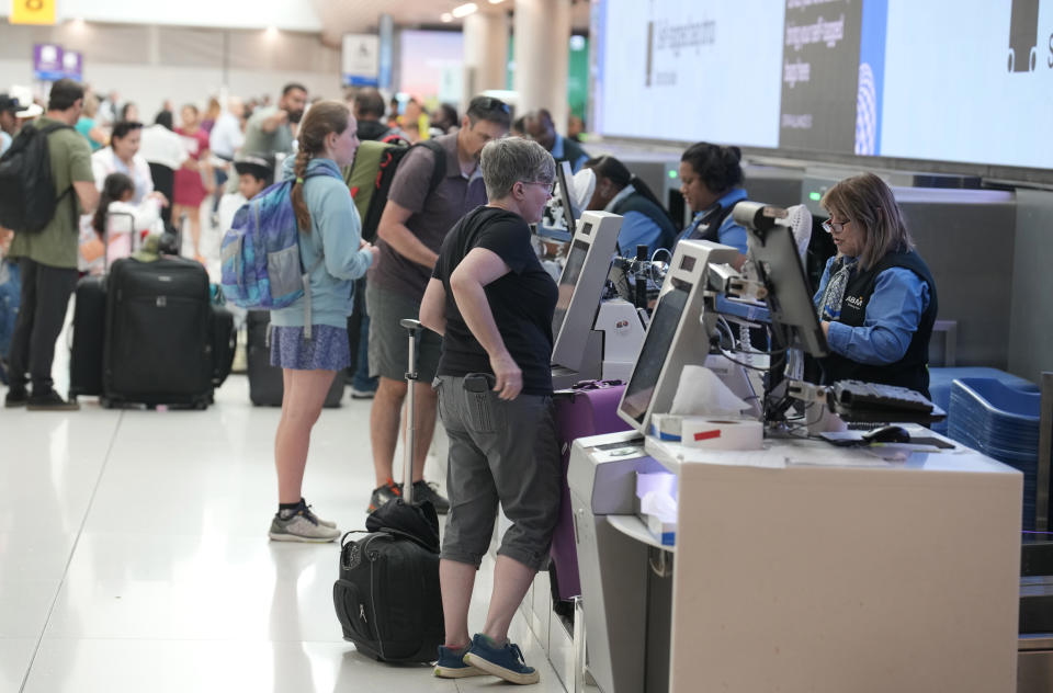 File - Travelers queue up at a United Airlines ticket counter in Denver International Airport Thursday, July 13, 2023, in Denver. The Federal Aviation Administration predicts Labor Day weekend will be the third busiest holiday travel weekend of the year so far. (AP Photo/David Zalubowski, File)