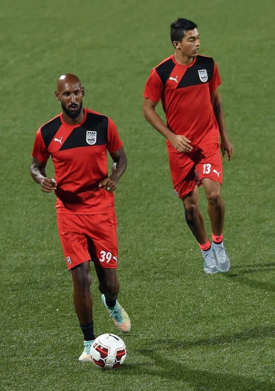 Mumbai City's Nicolas Anelka (L) warms up with a teammate during a training session in Mumbai, on October 1, 2015