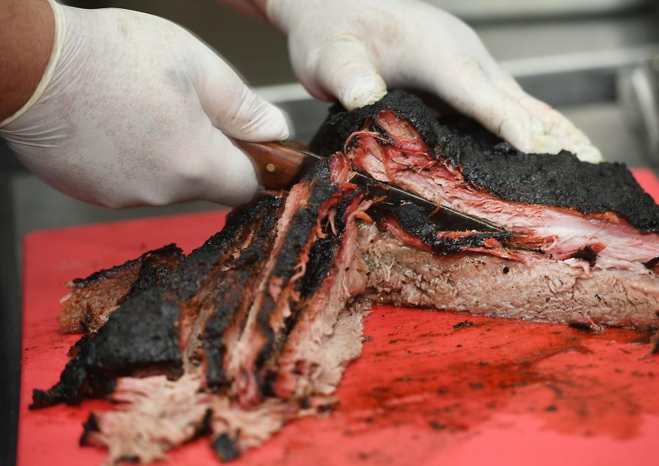 Jolly Rogers BBQ is now open in Pacolet. 
Josh Rogers prepares beef brisket for guests.