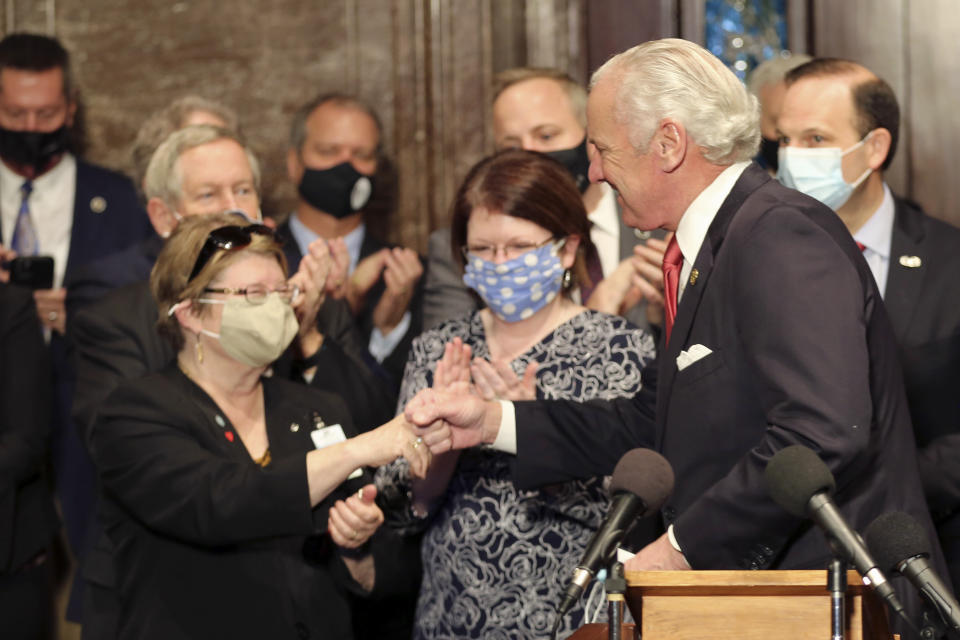 South Carolina Gov. Henry McMaster, right, fist bumps South Carolina Citizens for Life Executive Director Holly Gatling, left, before McMaster signed a bill banning almost all abortions in the state on Thursday, Feb. 18, 2021, in Columbia, S.C. On the same day, Planned Parenthood filed a federal lawsuit to stop the measure from going into effect. The state House approved the “South Carolina Fetal Heartbeat and Protection from Abortion Act” on a 79-35 vote Wednesday and gave it a final procedural vote Thursday before sending it to McMaster. (AP Photo/Jeffrey Collins)