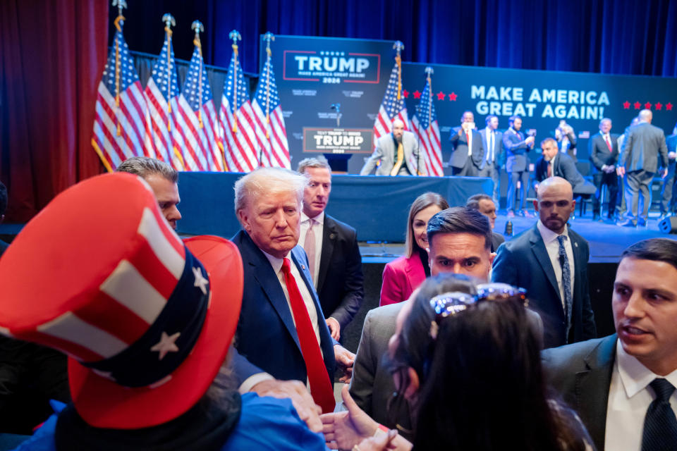 Former President Donald Trump greets supporters after a campaign stop in Davenport, Monday, March 13, 2023. 