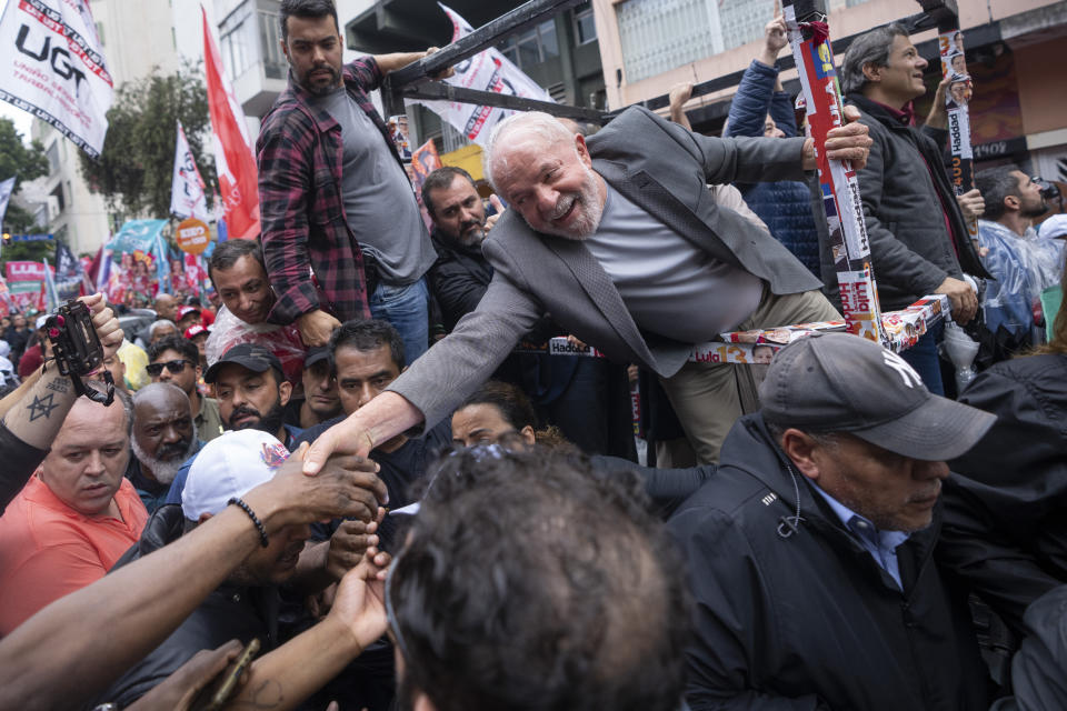 FILE - Brazil's former President Luiz Inacio Lula da Silva shakes hands with a supporter as he campaigns a day ahead of the country's general election, in Sao Paulo, Brazil, Saturday, Oct. 1, 2022. (AP Photo/Victor R. Caivano, File)