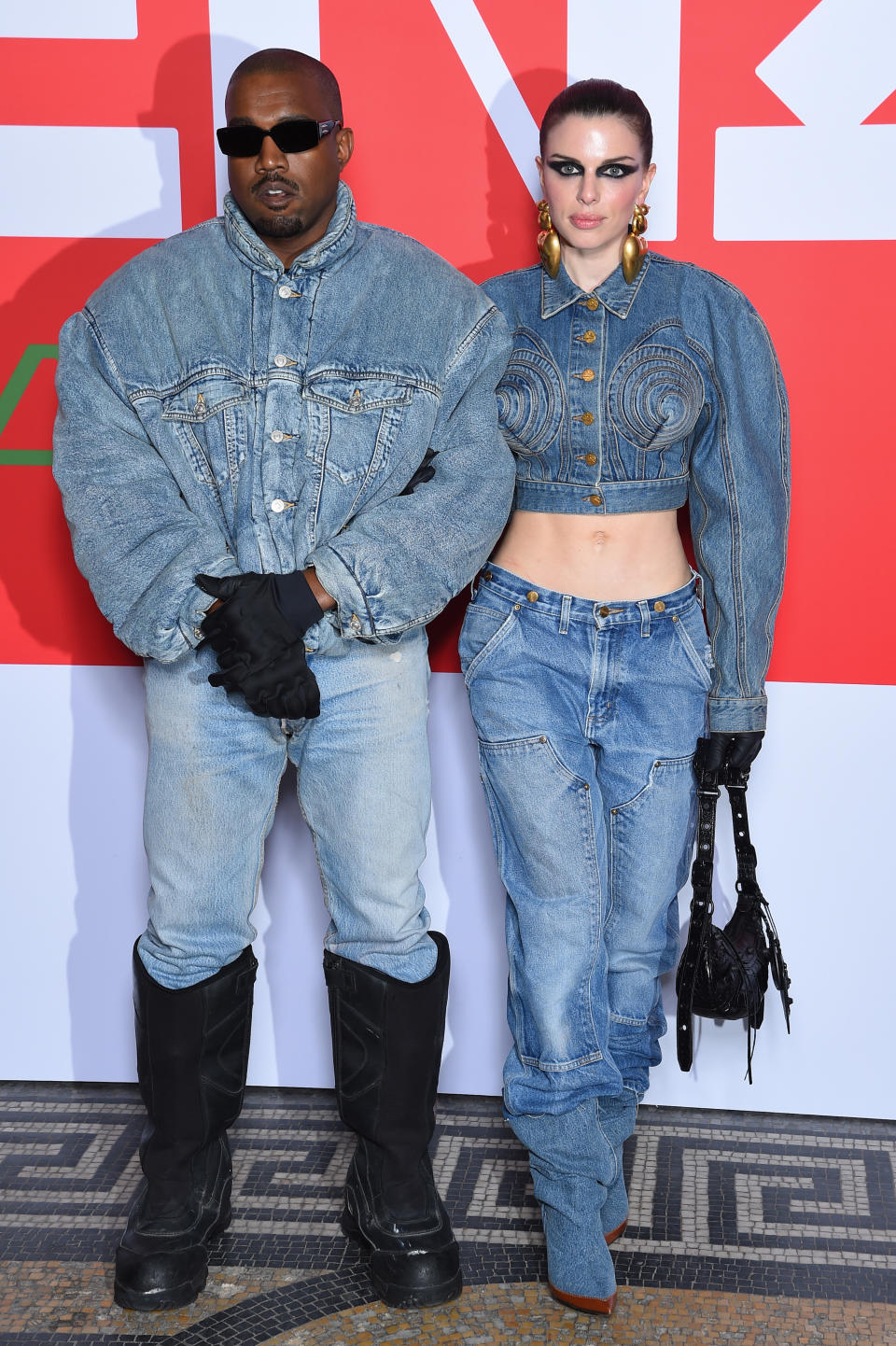 Kanye and Julia Fox posing together, they're both wearing bonkers outfits that are denim from head to toe
