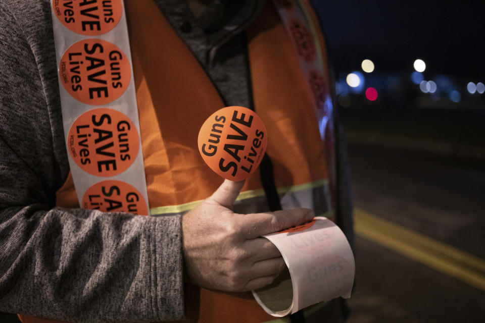 Volunteer Tom Kennedy from Campbell County passes out "Guns Saves Lives" stickers.