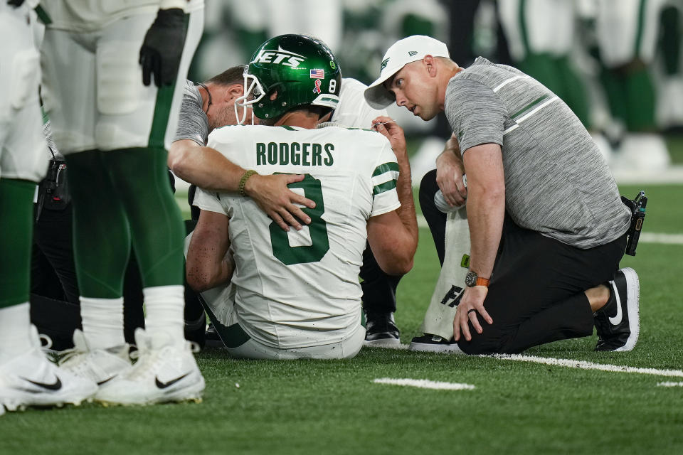 New York Jets quarterback Aaron Rodgers (8) is tended to on the field during the first quarter of an NFL football game against the Buffalo Bills, Monday, Sept. 11, 2023, in East Rutherford, N.J. (AP Photo/Seth Wenig)