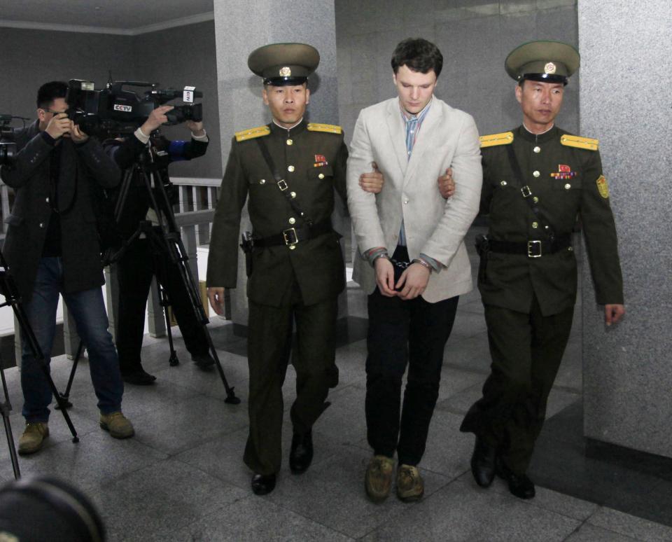 American student Otto Warmbier, center, is escorted at the Supreme Court, Wednesday, March 16, 2016, in Pyongyang, North Korea.