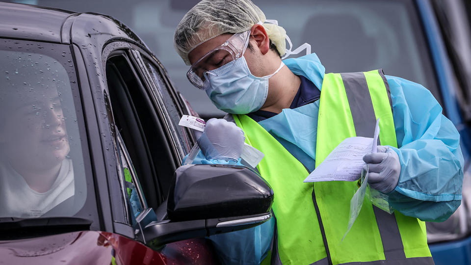 Seen here, a motorist is subjected to a random COVID-19 test in Sydney.