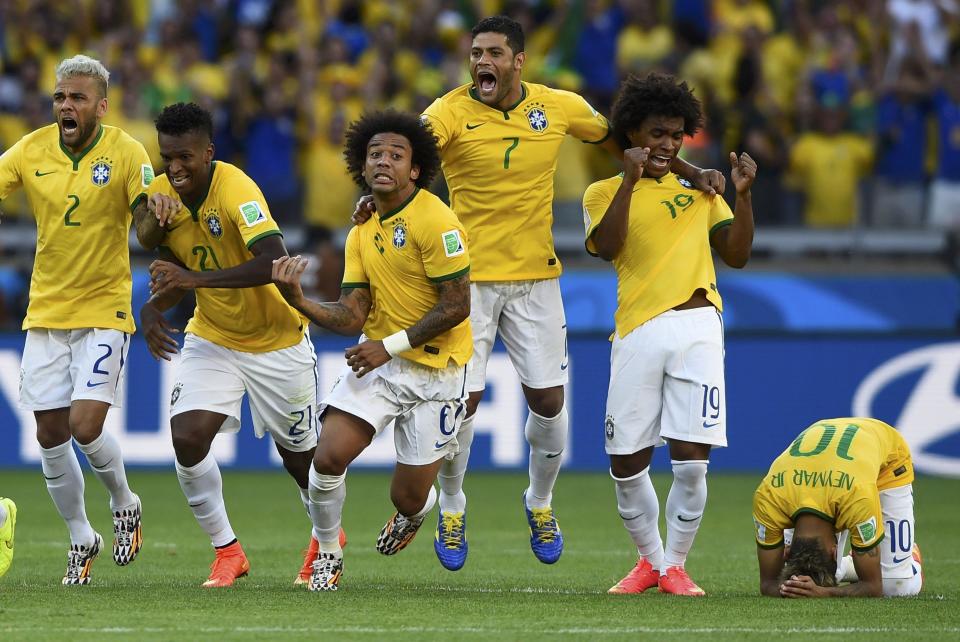 Brazil's national soccer players celebrate their penalty shootout win against Chile in their 2014 World Cup round of 16 game at the Mineirao stadium in Belo Horizonte