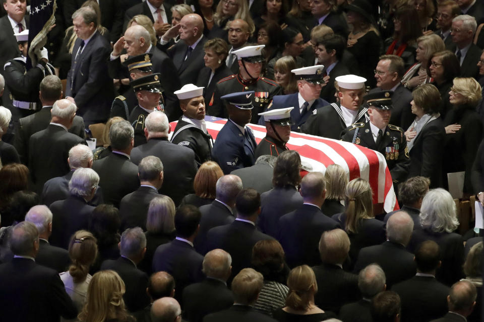 Bush's flag-draped casket is carried by a military honor guard.