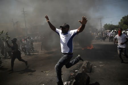 A protester gestures as he marches during a demonstration called by artists to demand the resignation of Haitian president Jovenel Moise, in the streets of Port-au-Prince